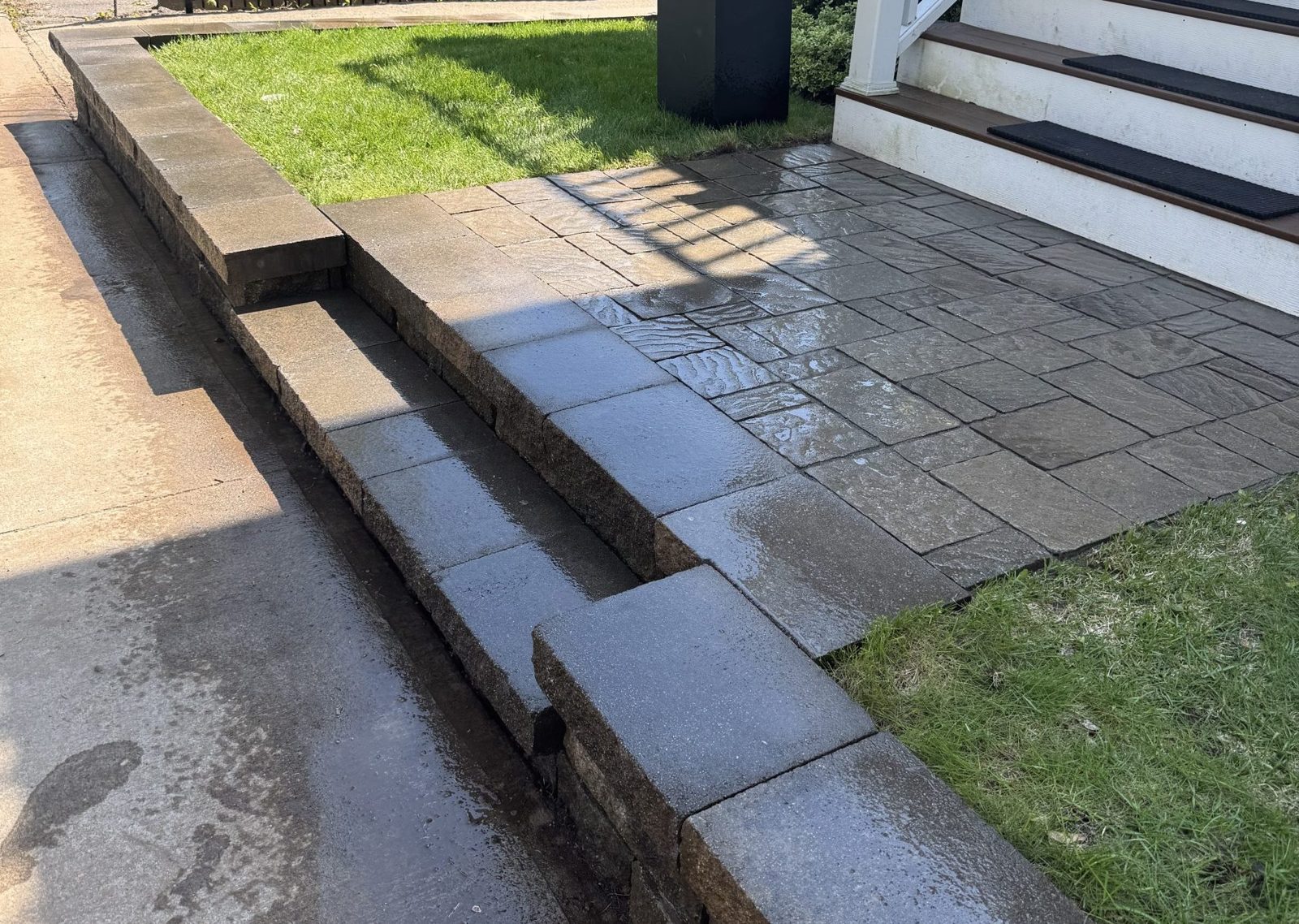 Stone retaining wall along a sloped yard